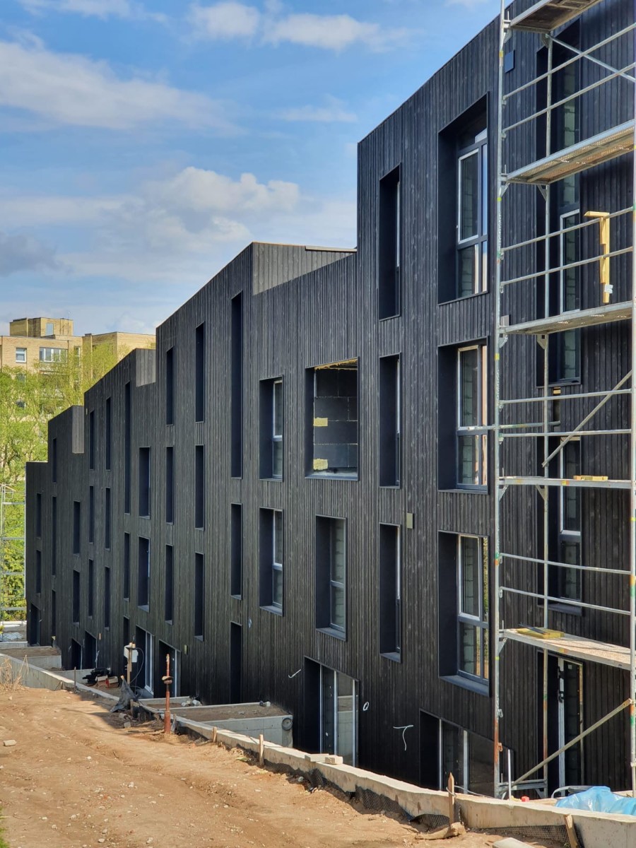 Huge apartment building with charred Larch wood siding