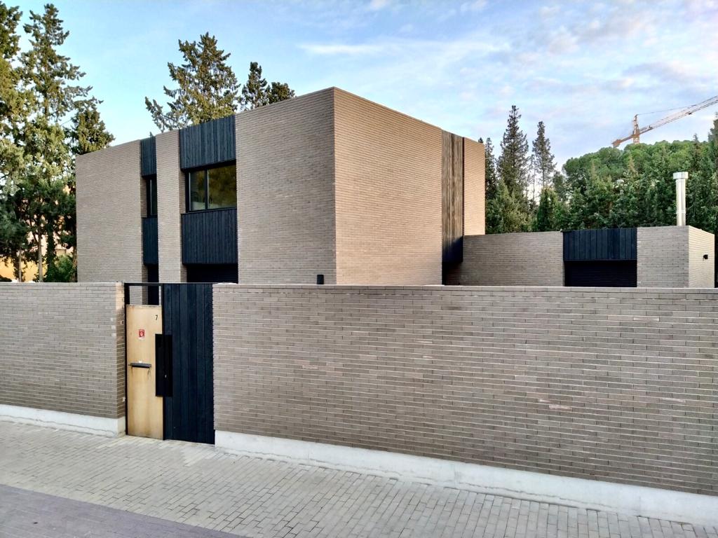 A house in a forest with Cedar siding