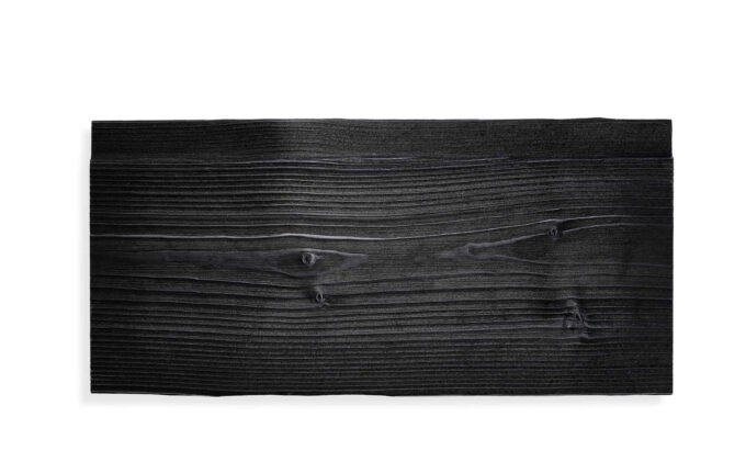 Dark stained wood plank with visible grain against a white background, showing the top edge and knots at the center and right.